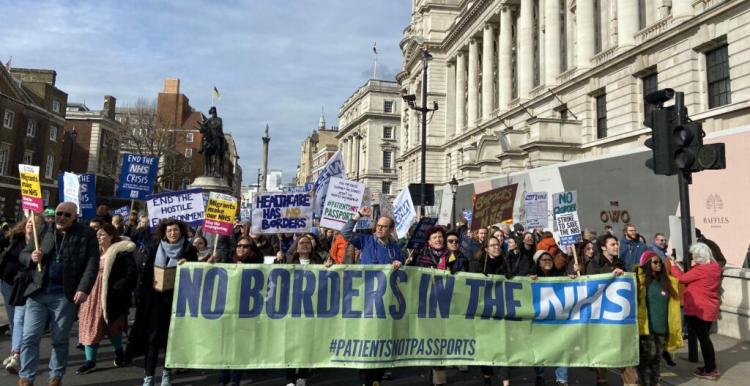 No borders in the NHS banner at demonstration