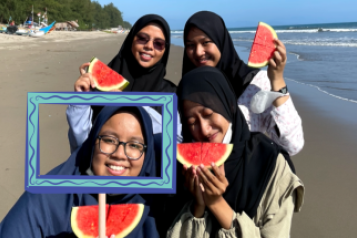 World Oral health Day girls on beach watermelons