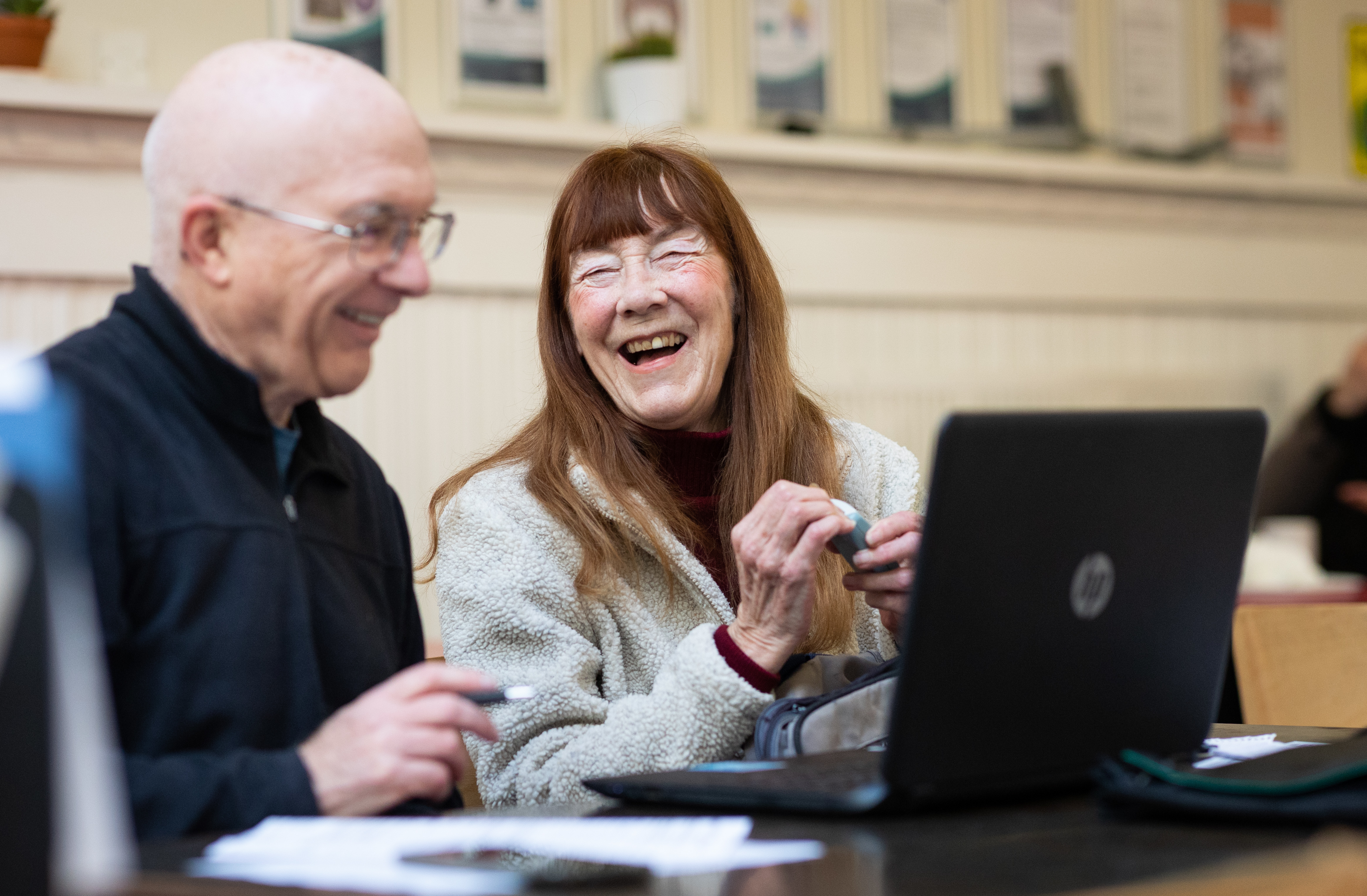 Older man and woman using laptop