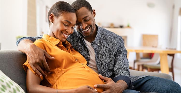 Pregnant woman and partner embracing