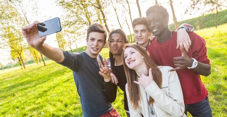 A group of young people pose for a selfie