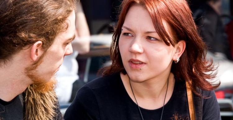 Young woman mid conversation with a young man