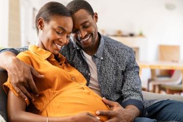 Pregnant woman and partner embracing