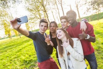 A group of young people pose for a selfie