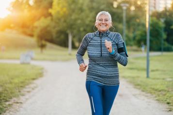 Older woman running in park