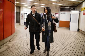 Blind man and woman walking