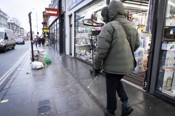 Blind person walking down high street