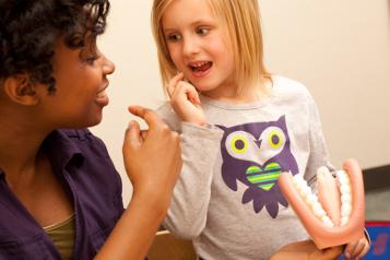 Speech therapist with young girl