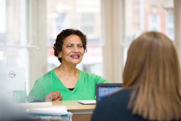 Female patient at reception desk 