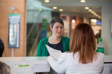 Woman speaking to a receptionist