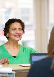 Female patient at reception desk 